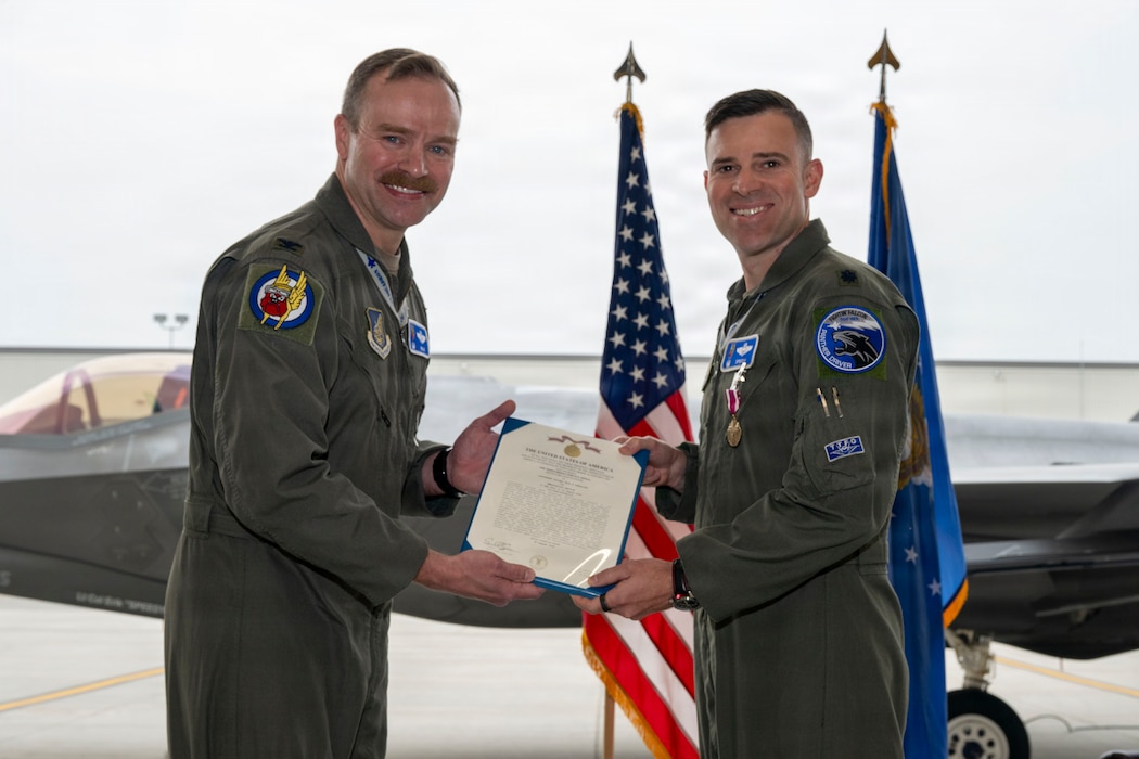 U.S. Air Force Lt. Col. Erik Gonsalves, 355th Fighter Squadron commander, right, receives the Meritorious Service Medal from U.S. Air Force Col. Samuel Chipman, 354th Operations Group commander, during a change of command ceremony at Eielson Air Force Base, Alaska, Aug. 14, 2026.