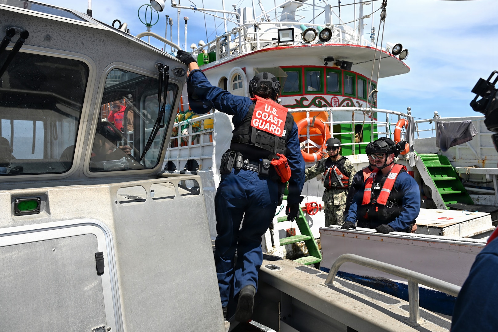 A U.S. Coast Guard boarding team from the Legend-class cutter Midgett (WMSL 757) prepares to transfer from the cutter’s long-range interceptor small boat to conduct a law enforcement boarding of a fishing vessel under Regional Fisheries Management Organizations (RFMO) authority in the Pacific Ocean, July 1, 2026. RFMO boardings ensure compliance with international fisheries regulations and counter illegal, unregulated and unreported fishing in the Pacific Ocean. (U.S. Coast Guard Photo by Petty Officer 3rd Class Austin Wiley)