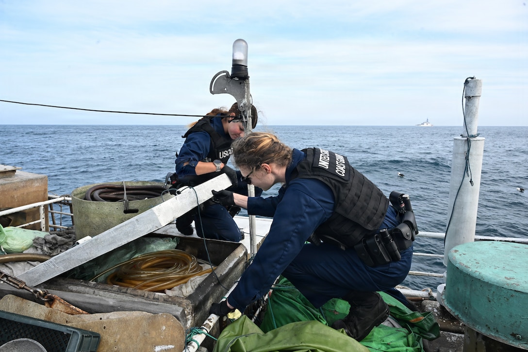 U.S. Coast Guard Lt. j.g. Madeline Mee, a boarding team member assigned to U.S. Coast Guard Legend-class cutter Midgett (WMSL 757), inspect a fishing vessel during a  law enforcement boarding under the Regional Fisheries Management Organizations (RFMO) authority in the Pacific Ocean, July 1, 2026. RFMO boardings ensure compliance with international fisheries regulations and counter illegal, unregulated and unreported fishing in the Pacific Ocean. (U.S. Coast Guard Photo by Petty Officer 3rd Class Austin Wiley)