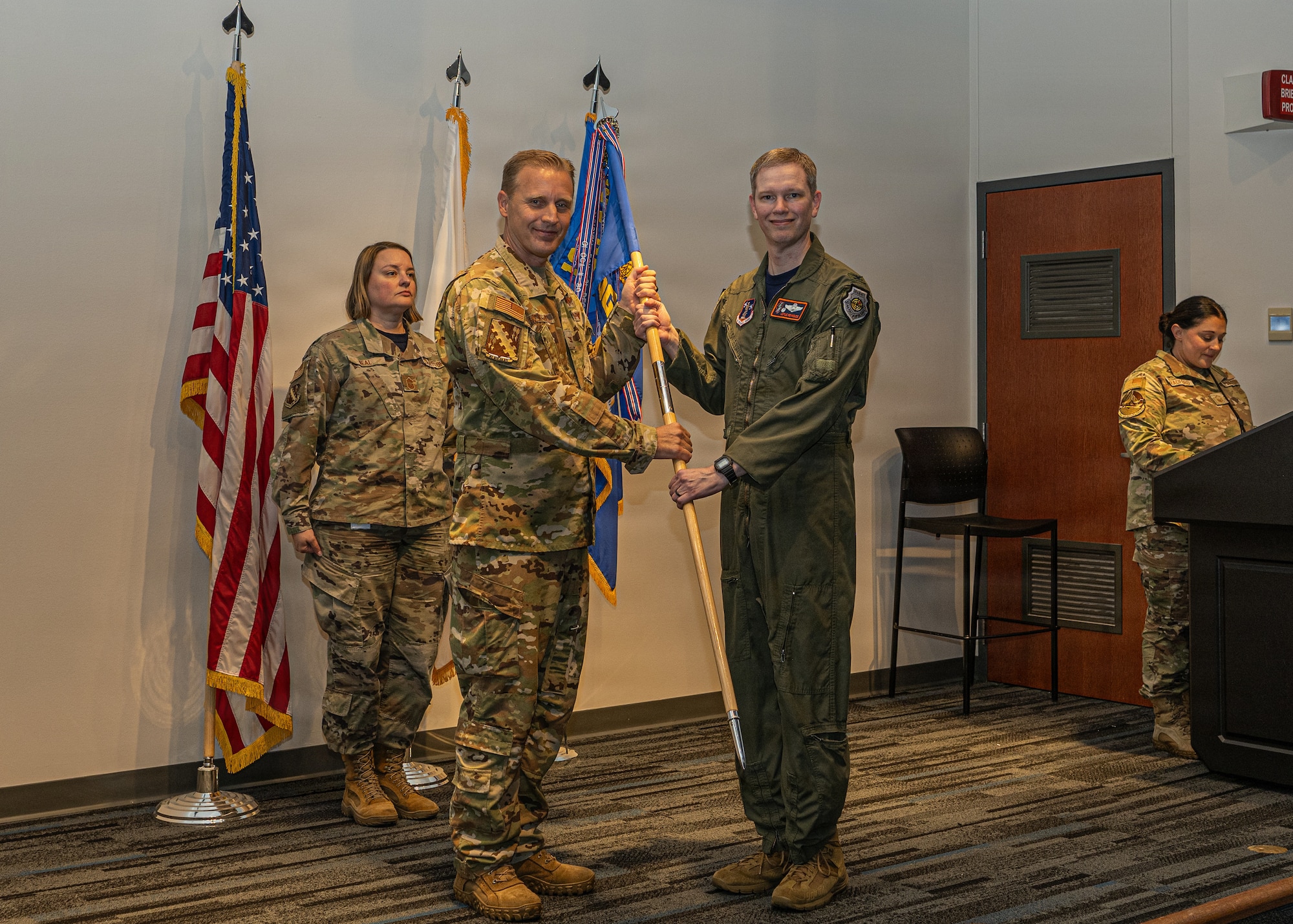 2 Airmen holding a guidon