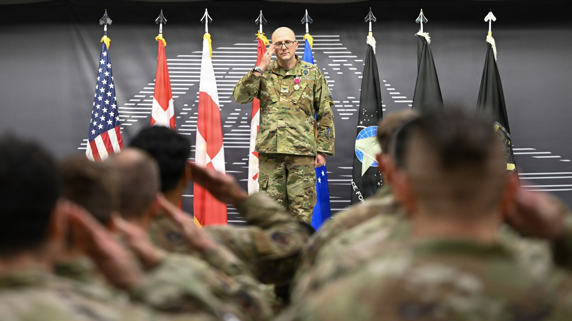 Col. Shawn Lee renders a salute to service members in formation.