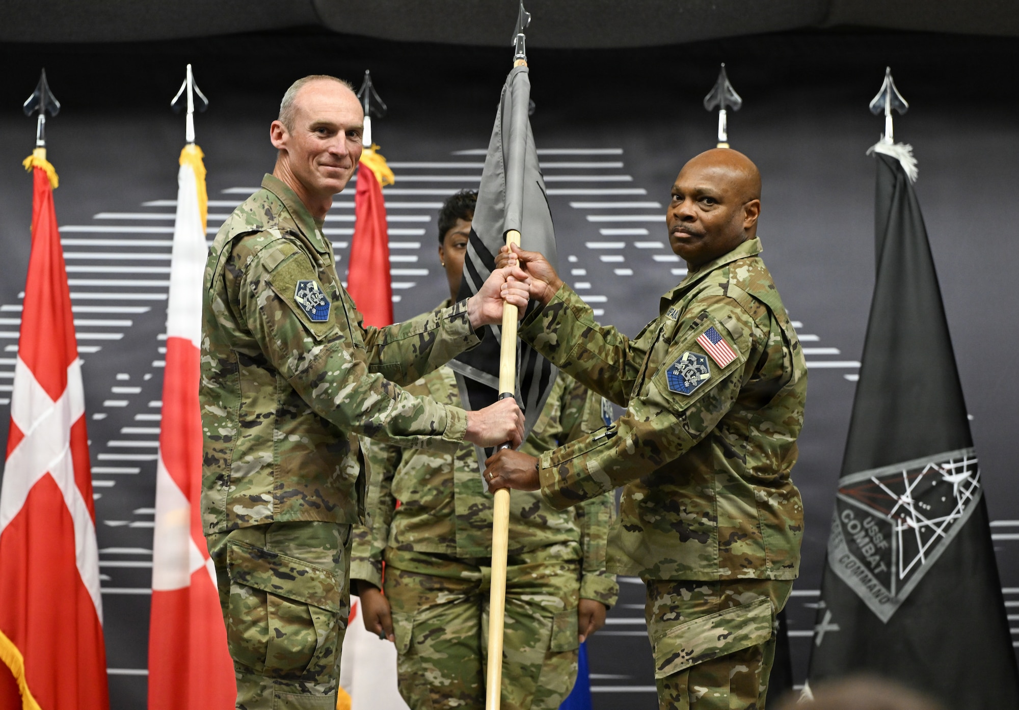 Col. Charles Cooper presents the 821st SBG guidon to Col. Keith Morris.