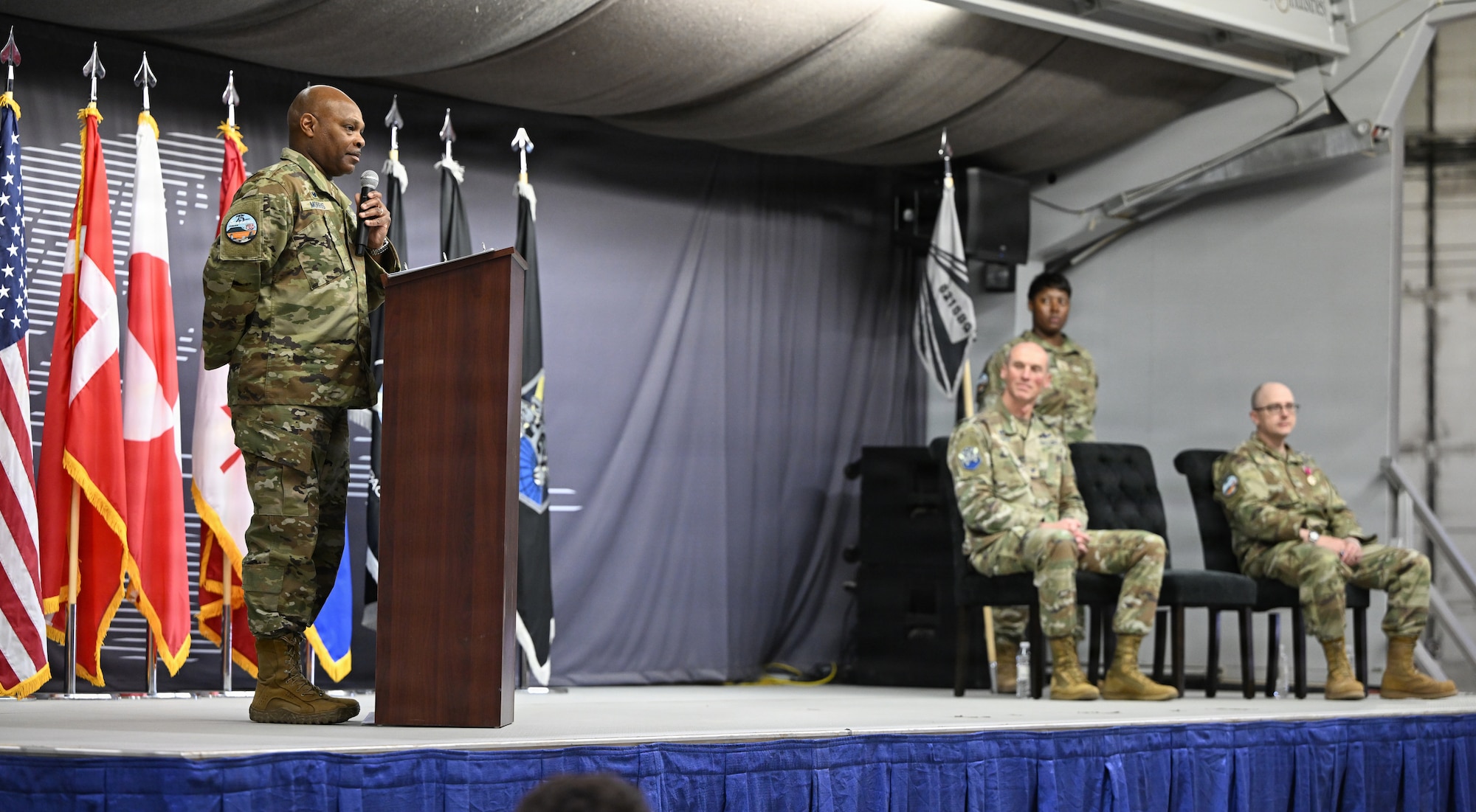 Col. Keith Morris addresses an audience from behind a podium.