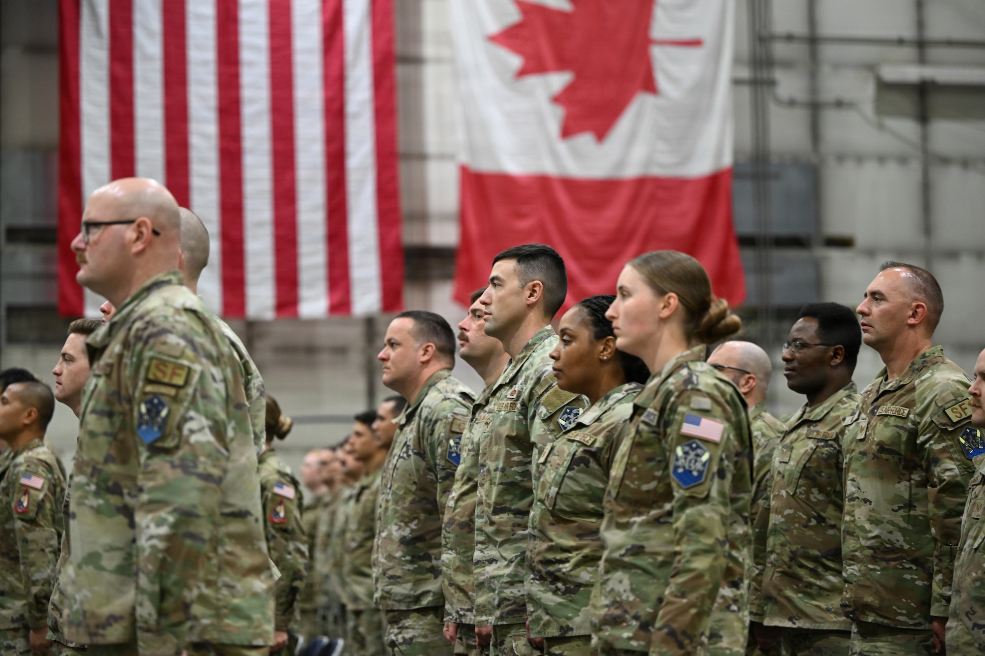 Airmen stand in formation.