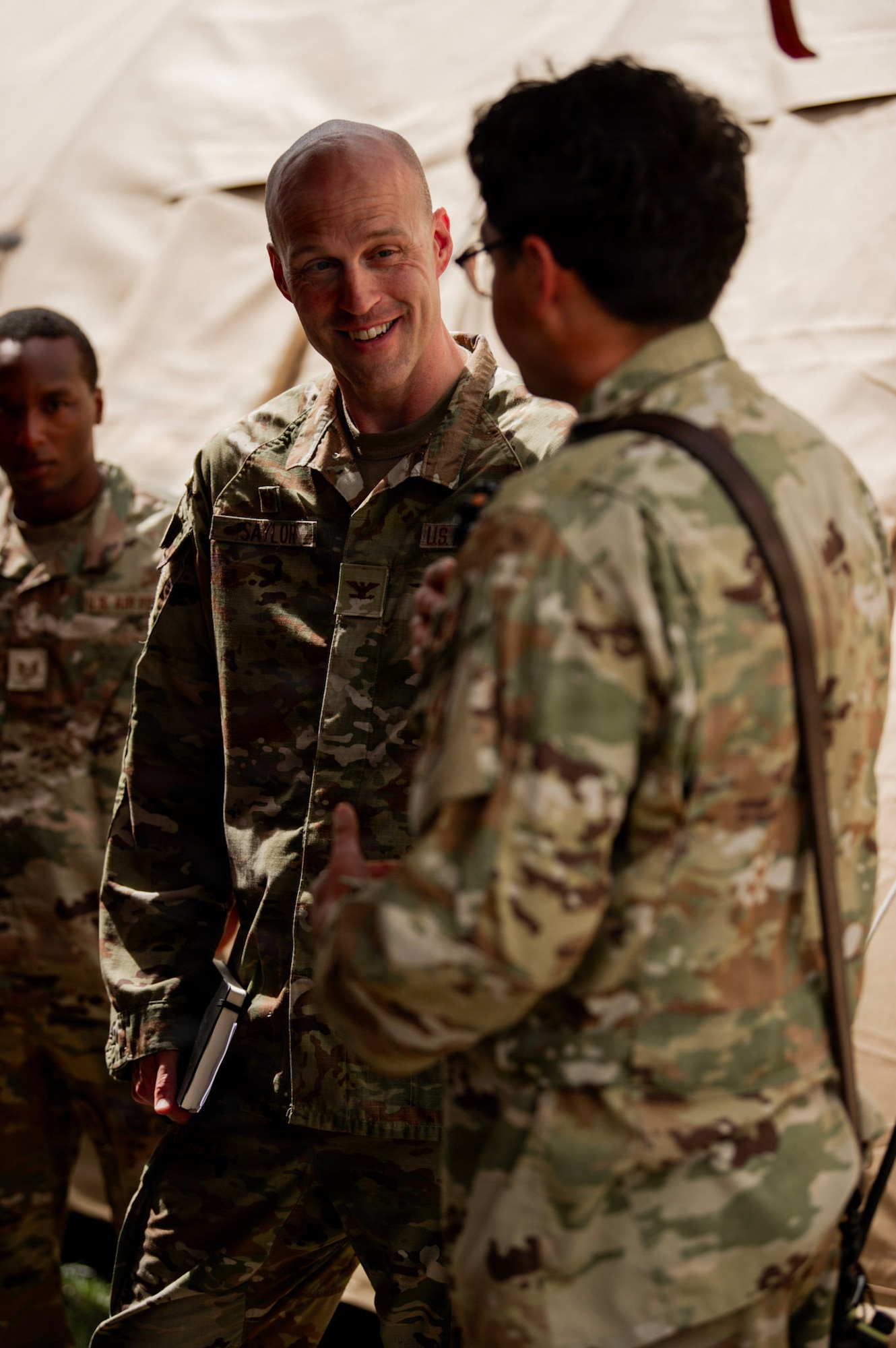 U.S. Air Force Col. Andrew Saylor, 449th Air Expeditionary Group commander, center, engages with U.S. Air Force Staff Sgt. Alexys Maida, 475th Expeditionary Air Base Squadron Civil Engineer Flight firefighter, during an immersion with the 475th EABS at Manda Bay, Kenya, August 8, 2026. The 475th EABS delivers agile airbase support that enables air operations, force protection and mission sustainment throughout the region. (U.S. Army photo by Sgt. Jake Anico)