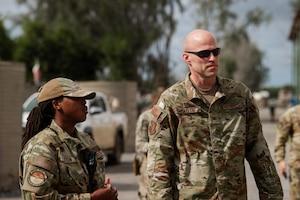 U.S. Air Force Col. Andrew Saylor, 449th Air Expeditionary Group commander, right, listens to a brief from U.S. Air Force Senior Airman Kailyn Natson, 475th Expeditionary Air Base Squadron Civil Engineer Flight firefighter, left, during an immersion at Manda Bay, Kenya, August 8, 2026. The 475th EABS delivers agile airbase support that enables air operations, force protection and mission sustainment throughout the region. (U.S. Army photo by Sgt. Jake Anico)