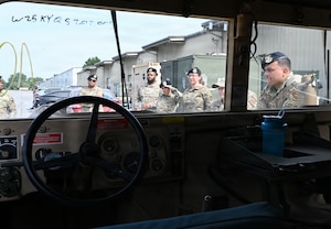 Defenders with the 512th Security Forces Squadron listen to instruction during Humvee familiarization training at Dover Air Force Base, Delaware, July 11, 2026. Twenty reservists completed the certification training.  (U.S. Air Force photo by Jeremy Larlee)