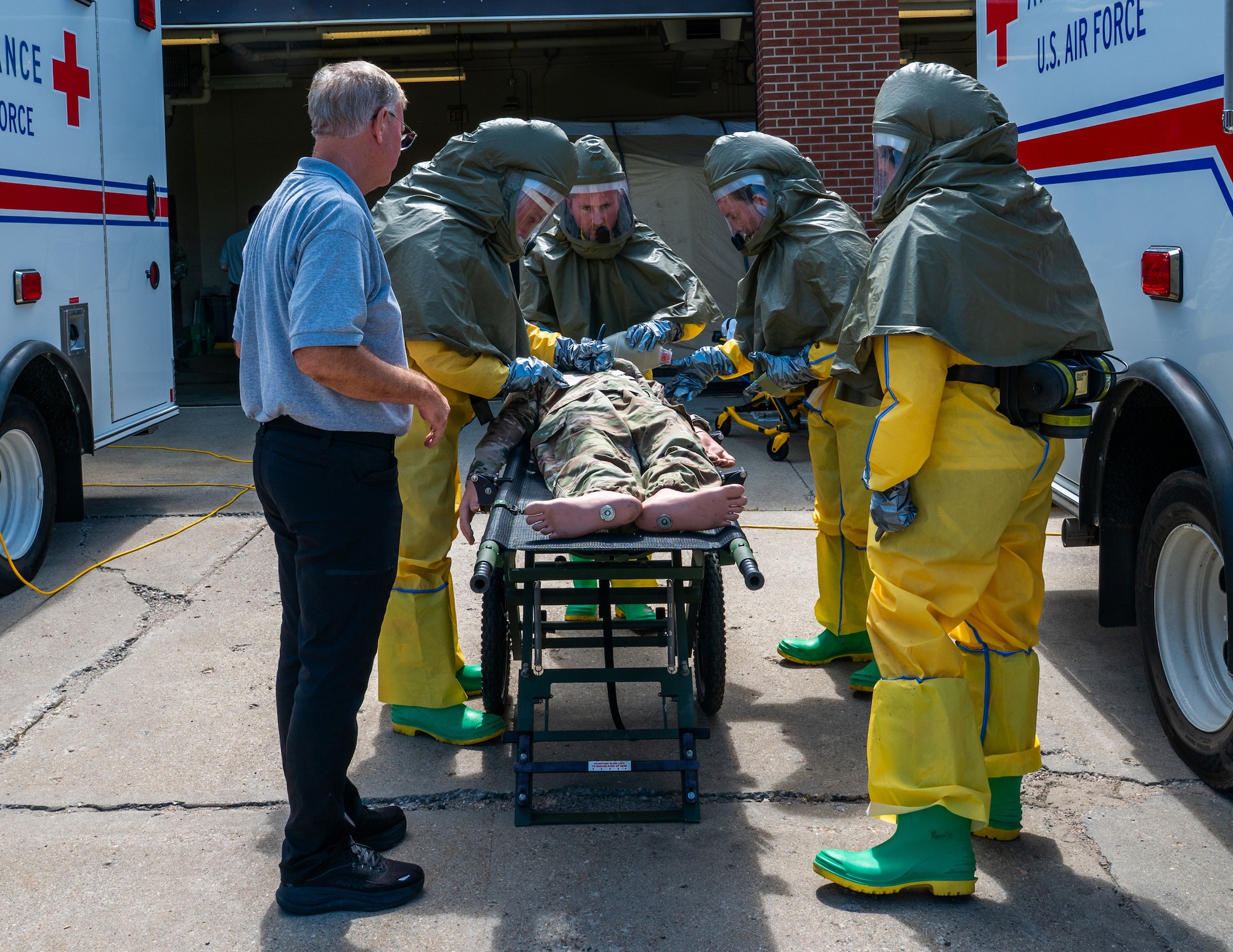 A photo of a group of people standing around a gurney.