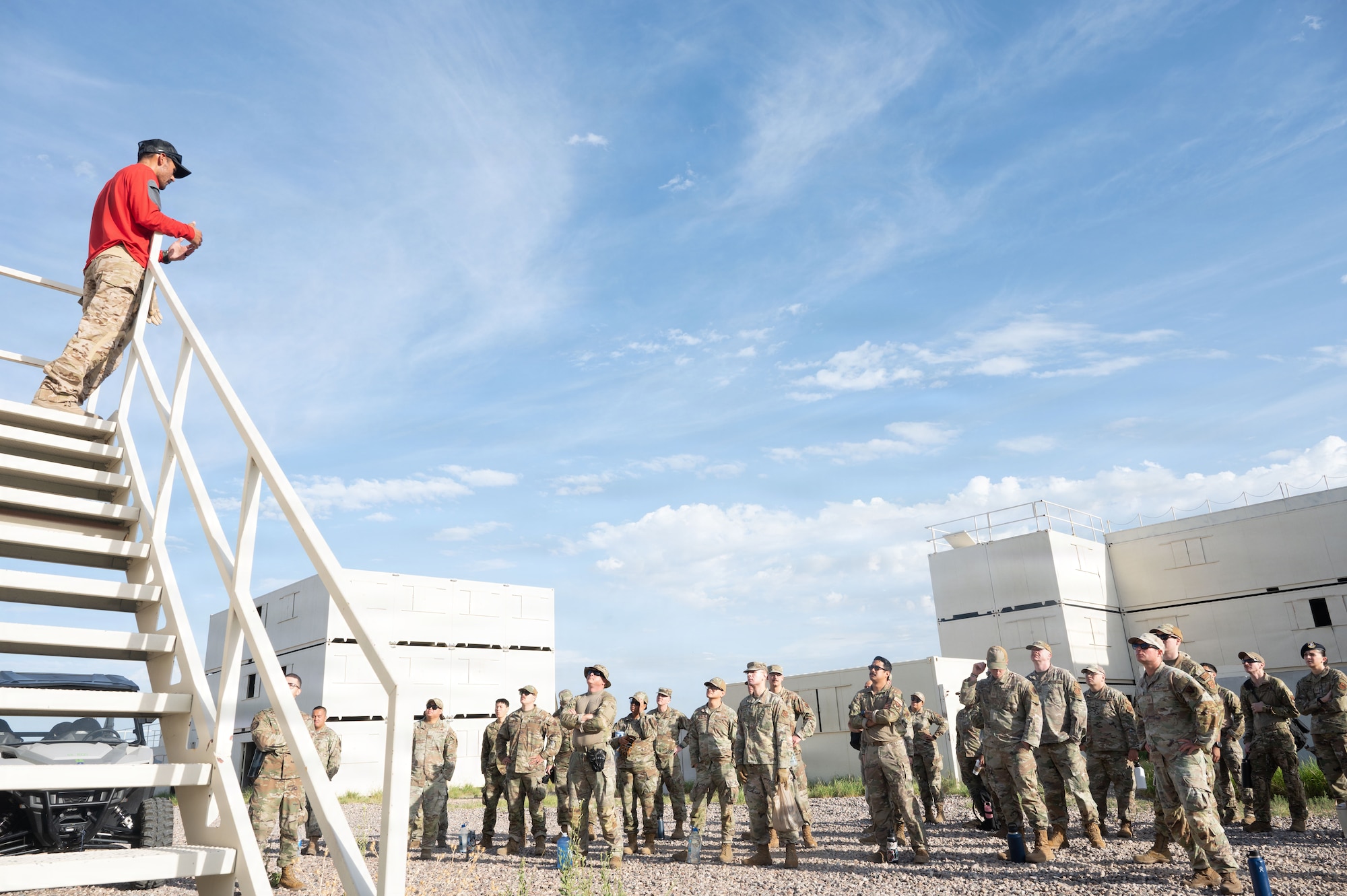 U.S. Air Force Tech. Sgt. Raul Martinez, assigned to the 68th Rescue Squadron, briefs Master Sergeant selects on the mission training exercise they will be participating in at Davis-Monthan Air Force Base, Arizona, Aug. 5, 2026. The 60 Master Sergeant selects participated in a round-robin style event, with four alternating stations testing communication under physical and mental stress, resource allocation and team problem-solving with ambiguous outcomes. (U.S. Air Force photo by Airman Najzee Kuzu)