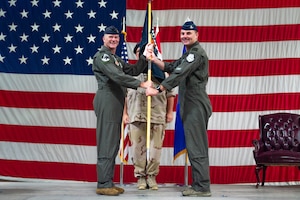 Royal Netherlands Air and Space Force Lt. Col. Joost Luijsterburg, outgoing 308th Fighter Squadron commander, passes the guidon to Lt. Col. Toon van de Graaf, incoming 308th FS commander, at Luke Air Force Base, Arizona, Aug. 14, 2026.