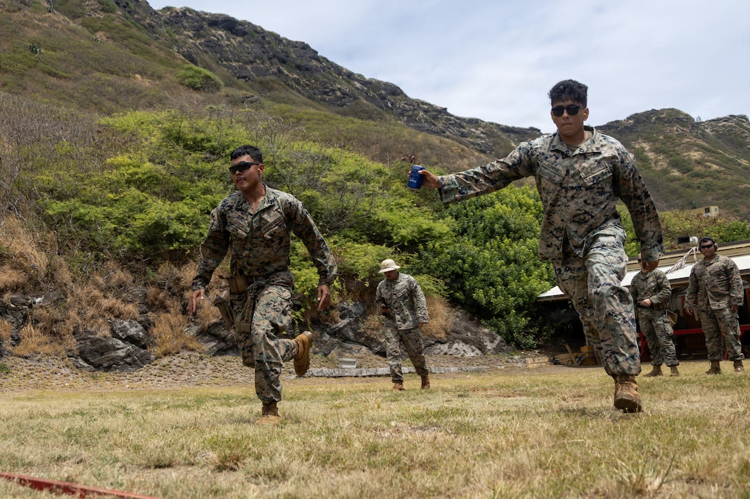 U.S. Marines stationed at Marine Corps Base Hawaii, participate in a live-fire exercise during an intramural shooting competition at MCBH, July 22, 2026. The multi-day competition showcased Marines' rifle and pistol marksmanship skills while exercising technical and tactical proficiency under high-pressure, combat-simulated conditions. Participants were pushed to their limits through rigorous dynamic firing drills, split-second decision-making, and advanced weapons handling. (U.S. Marine Corps photo by Lance Cpl. Nicholas Figueroa)