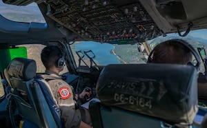 The view of a cockpit and a river in the foreground.