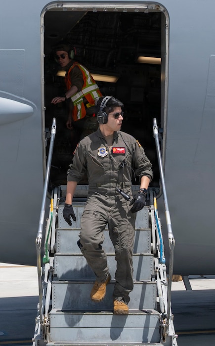 A pilot walking off a plane.