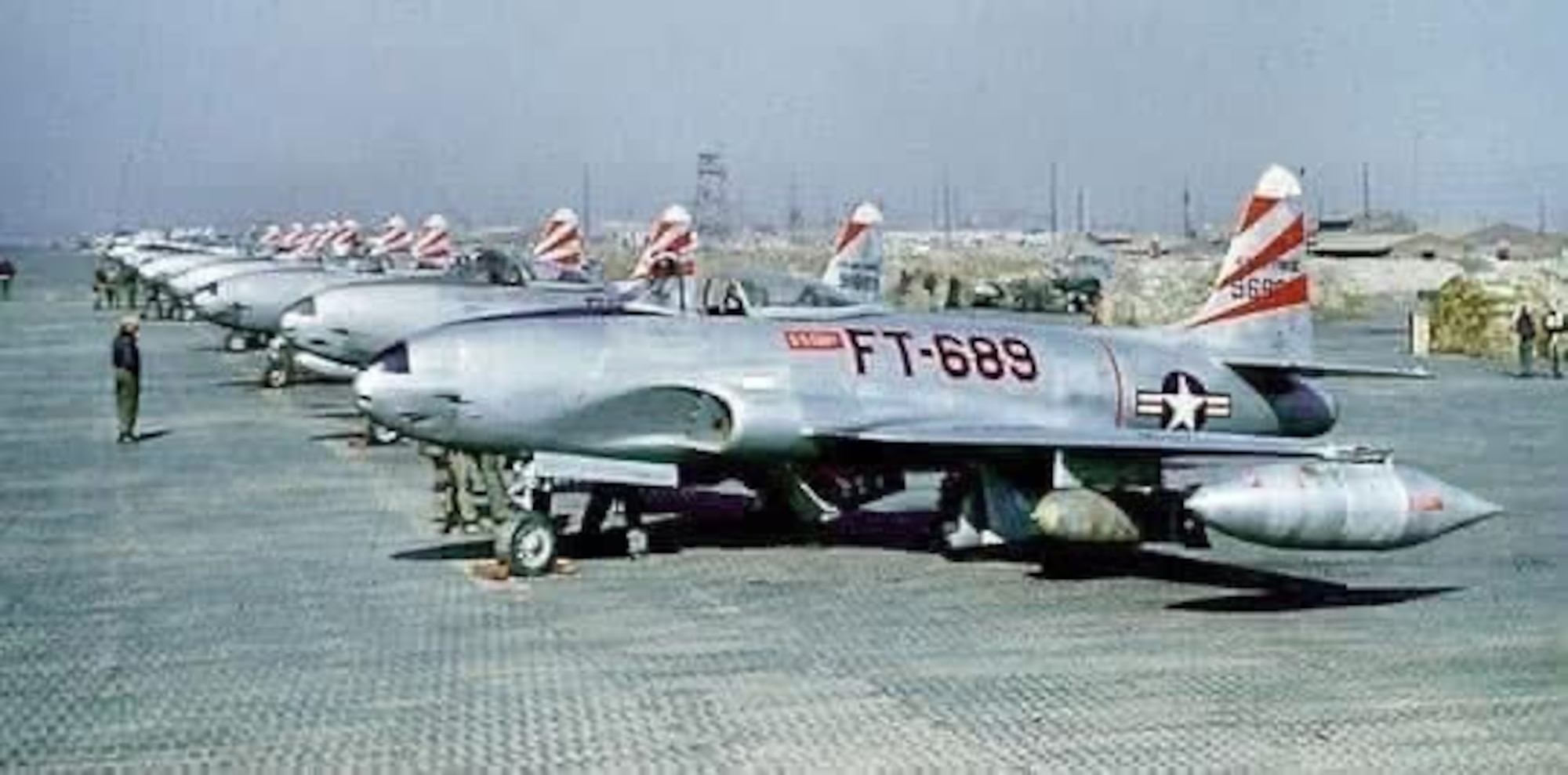 Lockheed F-80C Shooting Stars lined up on a pierced steel planking (PSP) ramp in Korea circa 1950.