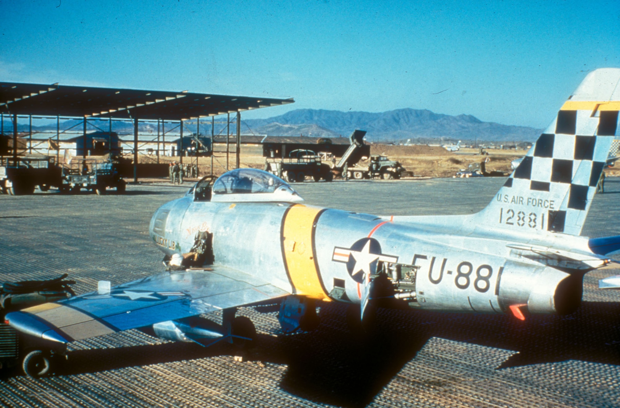A 51st Fighter-Interceptor Wing F-86F Sabre (Tail No. 12881, "Lucky Lib") sits on the pierced steel planking runway at Suwon Air Base (K-13), South Korea, during the Korean War.