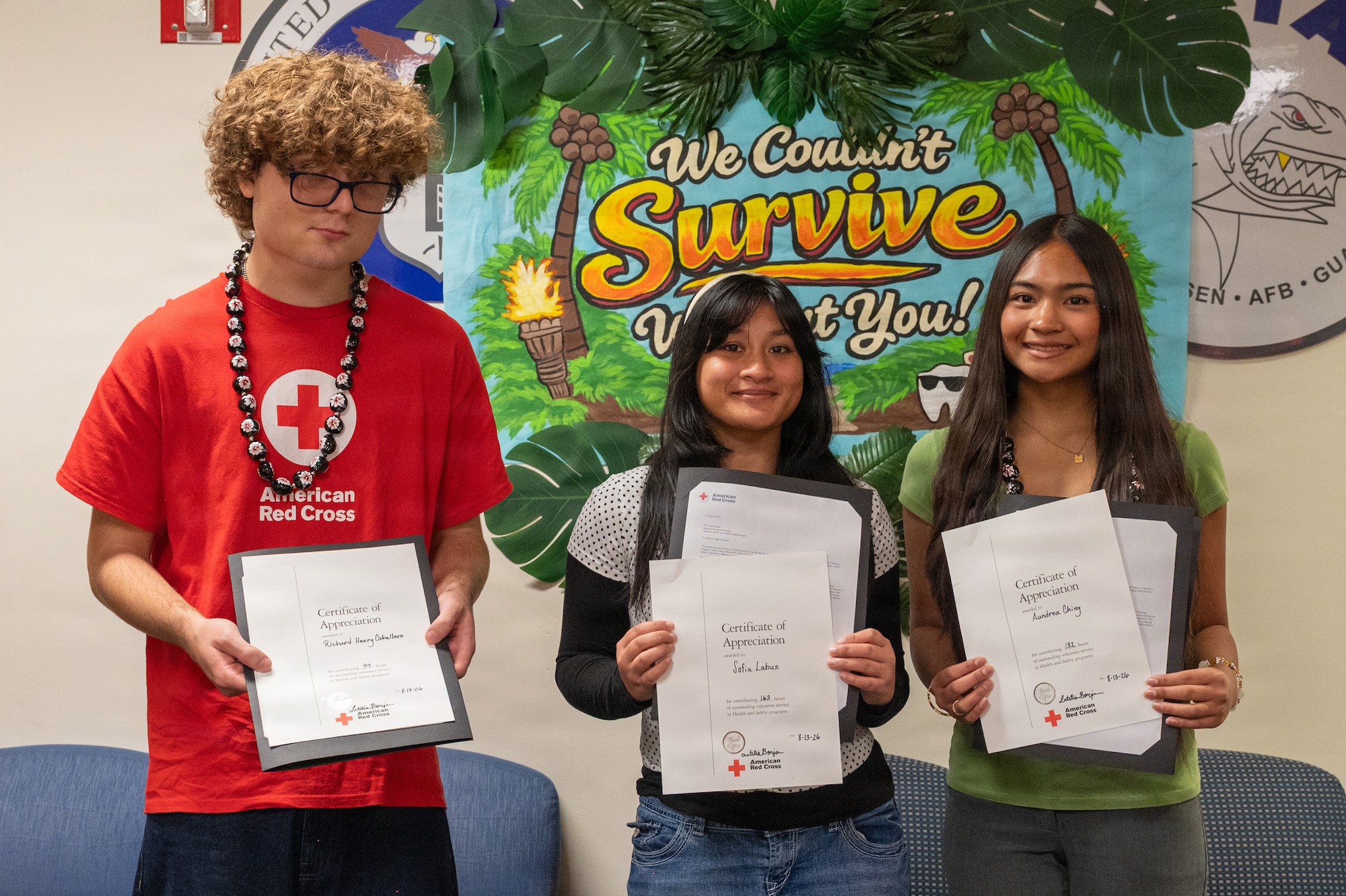 American Red Cross VolunTEENs Richard Henry Caballero, left, Sofia Labus, center, and Aundrea Ching, right, display their certificates of appreciation during the VolunTEEN summer program closing ceremony at Andersen Air Force Base, Guam, Aug. 13, 2026. Participants gained firsthand experience in a military medical environment while working alongside Airmen, civilian employees and medical professionals. (U.S. Air Force photo by Airman 1st Class Charline Ebreo)