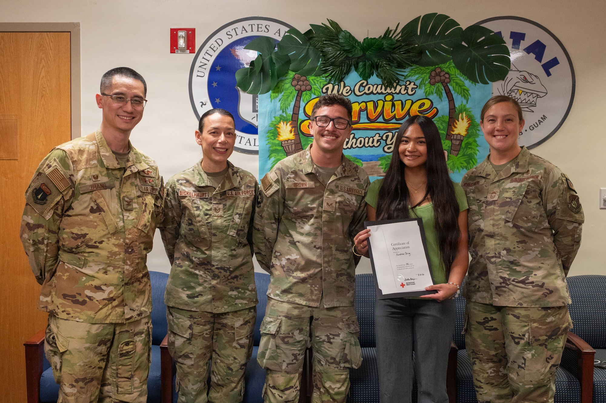Members of the 36th Medical group pose with American Red Cross VolunTEEN Aundrea Ching after presenting her with a certificate of appreciation during the program’s closing ceremony at Andersen Air Force Base, Guam, Aug. 13, 2026. VolunTEENs rotated through multiple departments within the 36th MDG, where they explored potential career fields and developed professional skills. (U.S. Air Force photo by Airman 1st Class Charline Ebreo)