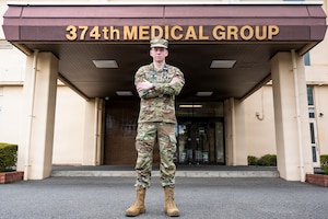 U.S. Air Force Capt. Zachary Hicks, 374th Health Care Operations Squadron, family medicine physician, poses for a photo outside the 374 HCOS at Yokota Air Base, Japan, Aug. 11, 2026.