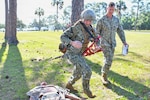 Hospital Corpsman 1st Class Austin Peevey, instructs Hospitalman Sara Hoffer, both assigned to Navy Medicine Readiness and Training Command Pensacola, during a Tactical Combat Casualty Care (TCCC) Final Exercise at Naval Hospital Pensacola, Pensacola, Florida, April 17, 2026. Peevey was recognized for his TCCC efforts during Operation Enduring Freedom and for the his ability of being a TCCC instructor.  (U.S. Navy photo by Mass Communication Specialist Seaman Jon Jezreel Andres)