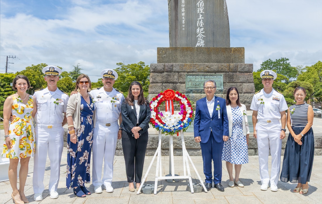 YOKOSUKA, Japan (July 11, 2026) - YOKOSUKA, Japan (July 11, 2026) - U.S. Navy leadership, international dignitaries, and local Japanese officials pose for a group photo during a memorial ceremony in Perry Park on. Pictured are: Mrs. Arnold and Capt. Arnold, commanding officer, Naval Supply Systems Command Fleet Logistics Center Yokosuka; Mrs. Hopkins, and Capt. Jon Hopkins, commanding officer, commander, fleet activities yokosuka (CFAY); Leana Lopez, acting political-military affairs counselor representative, U.S. Embassy; Katsuaki Kamiji, mayor of Yokosuka City; Mrs. Kamiji; Capt. John Beattie, commanding officer, Naval Facilities Engineering Systems Command Far East, and Mrs. Beattie. The ceremony commemorated the 173rd anniversary of Commodore Matthew C. Perry's landing in Kurihama, celebrating the enduring alliance between the United States and Japan. CFAY provides, maintains, and operates base facilities and services in support of the U.S. 7th Fleet's forward-deployed naval forces, 71 tenant commands, and more than 27,000 military and civilian personnel and their families. (U.S. Navy photo by Sheryl Sullivan)