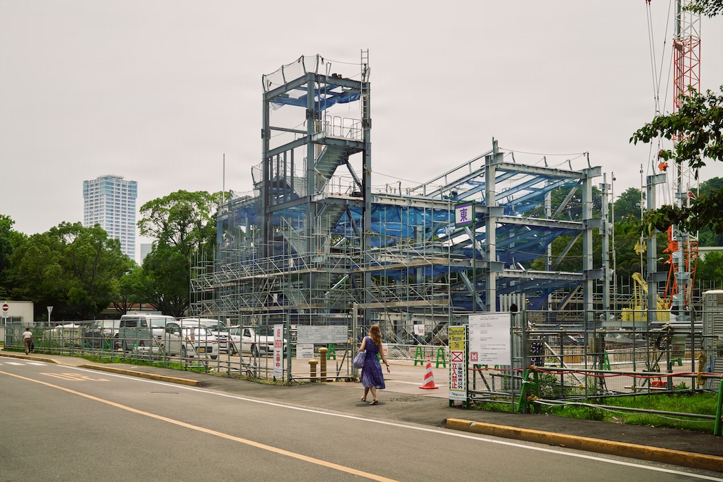 FLEET ACTIVITIES YOKOSUKA, Japan (July 16, 2026) -- The frame of a parking structure begins to take shape at the site of NA1807, a multi-level steel facility designed to provide approximately 460 privately-owned vehicles, July 16, 2026. The site was a street parking lot serving Kyuban and Jyuban Unaccompanied Housing (UH Towers. The expansion includes support for four additional UH complexes and is estimated to be complete by the end of 2027. (U.S. Navy photo by James Kimber)