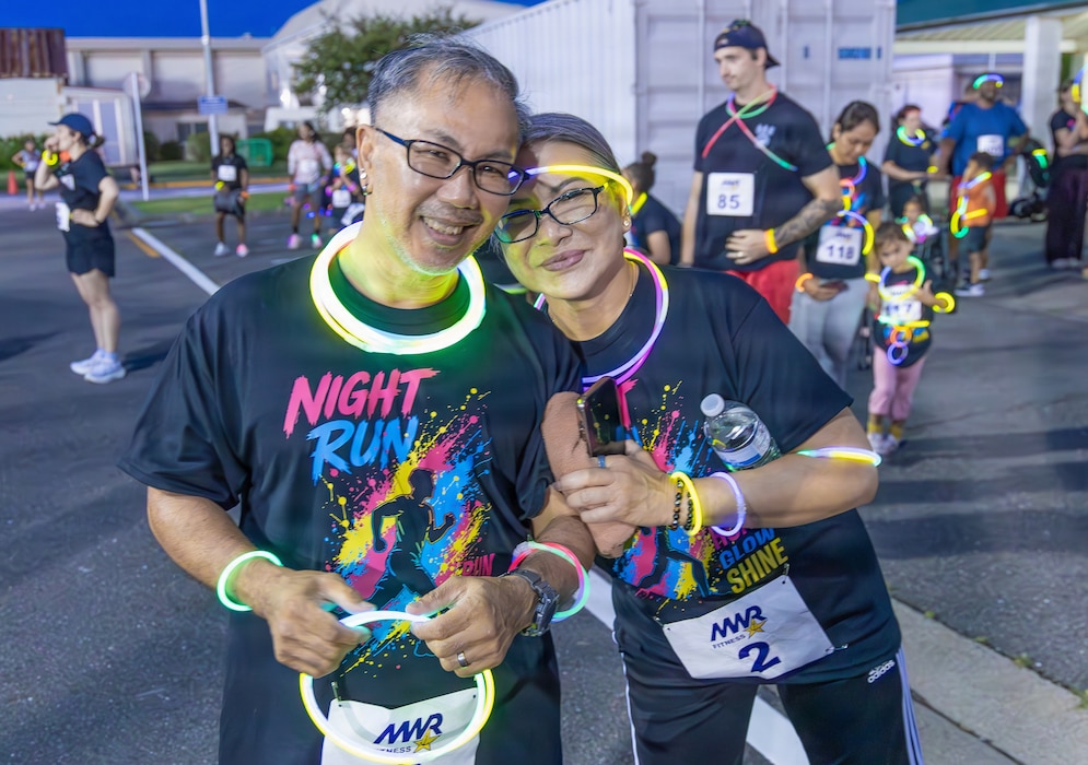 YOKOSUKA, Japan (Aug. 15, 2026) – Participants pose for a photo before the start of the annual Morale, Welfare and Recreation (MWR) Night Run outside the Purdy Fitness Center onboard Commander Fleet Activities Yokosuka (CFAY). Hosted by CFAY MWR, the evening event brought together participants of all ages wearing high-visibility gear to promote physical fitness and community wellness. CFAY provides, maintains and operates base facilities and services in support of the U.S. 7th Fleet's forward-deployed naval forces, 71 tenant commands and more than 27,000 military and civilian personnel and their families. (U.S. Navy photo by Sheryl Sullivan)