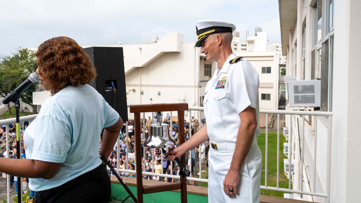 FLEET ACTIVITIES YOKOSUKA, Japan (Aug. 17, 2026) - Cmdr. Andrew Cotherman, Fleet Activities Yokosuka public works officer, rings a bell to open the school year during a Ring-In Ceremony at Sullivans Elementary School at Fleet Activities Yokosuka. The Ring-In Ceremony is a longstanding tradition marking the start of the academic year for incoming students. (U.S. Navy photo by Mass Communication Specialist 2nd Class Quinton A. Lee)