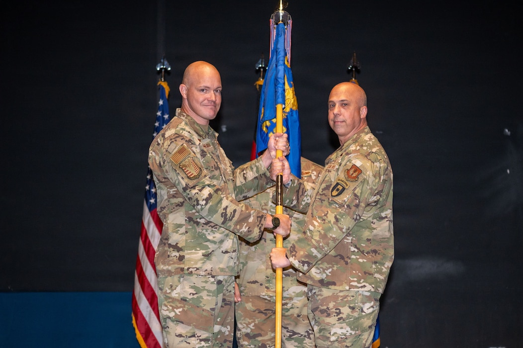 U.S. Air Force Col. Kevin D. Monaghan, right, 86th Aeromedical Evacuation Squadron incoming commander, assumes command of the 86th AES from Col. Matthew Wunderlich, left, 86th Operations Group commander, during the 86th AES assumption of command ceremony.