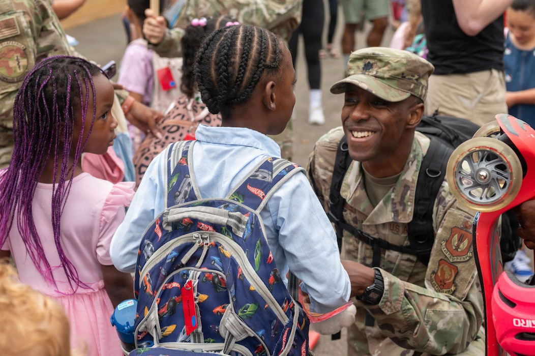 A parent drops off their children for the first day of school.