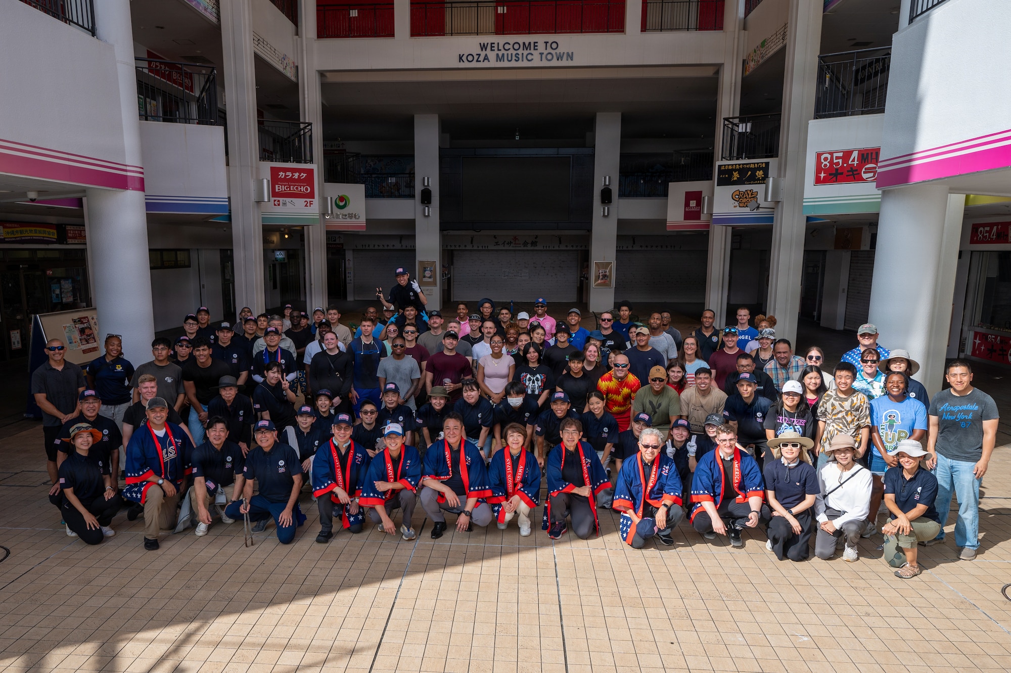 Service members and locals pose for group photo.