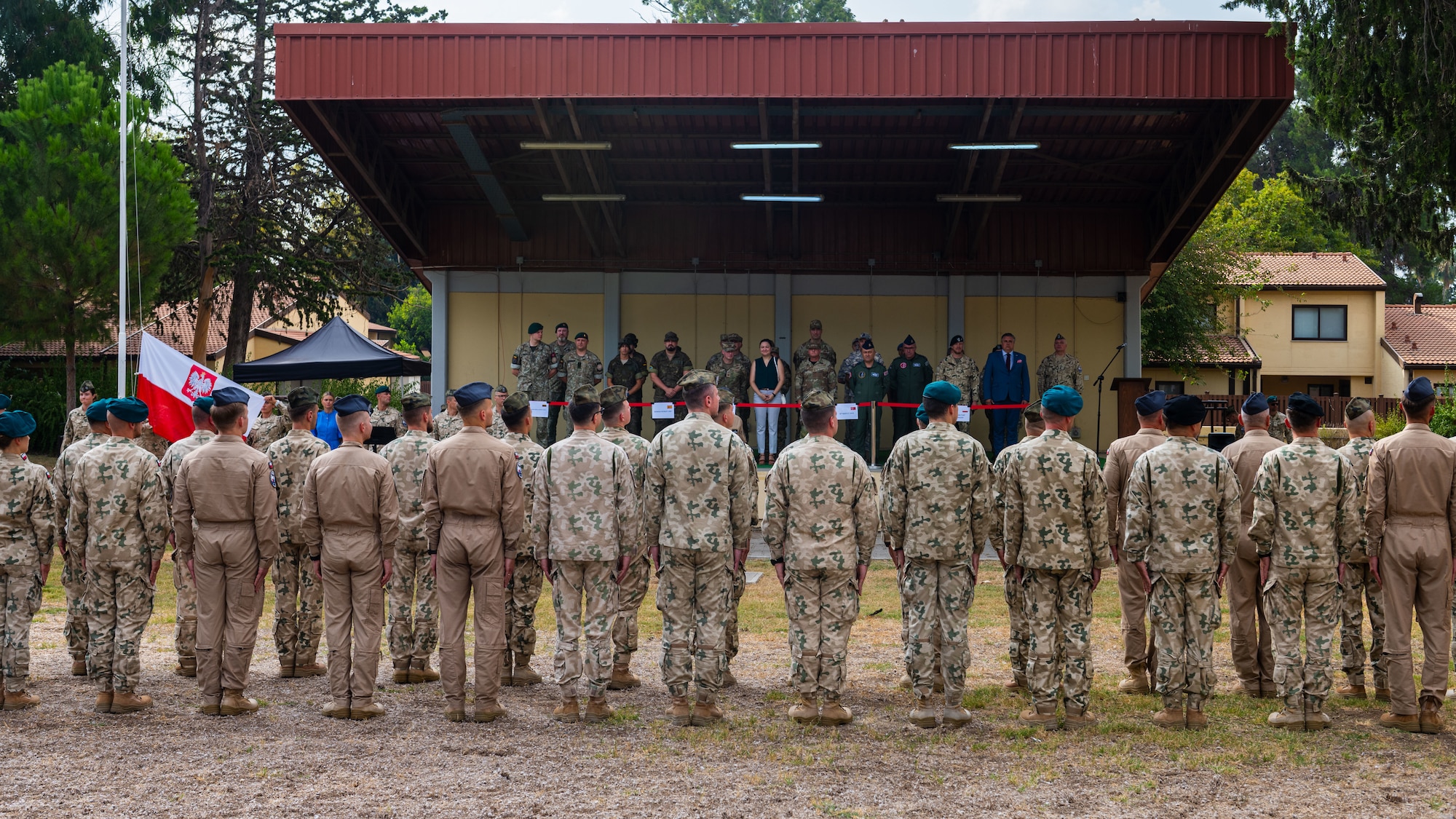 Members assigned to the Polish Military Contingent and distinguished guests attend a Polish Armed Forces Day ceremony.
