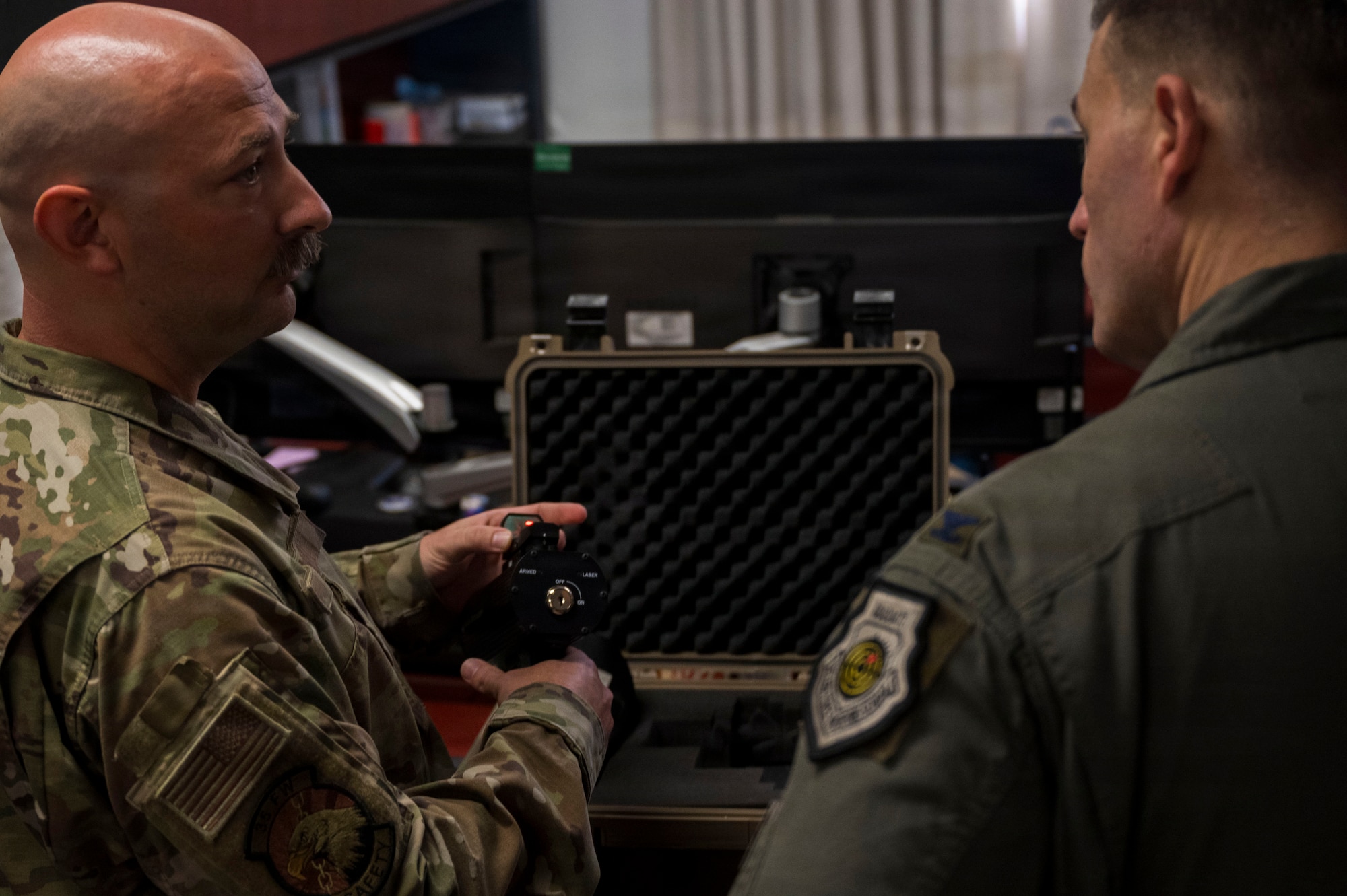 U.S. Air Force Tech. Sgt. Christopher Frank, left, 35th Fighter Wing aviation safety noncommissioned officer, briefs Col. Oliver Lause, 35th FW commander, on the Avian Dissuader during a Wild Weasel Walk-Through at Misawa Air Base, Japan, Aug. 18, 2026.