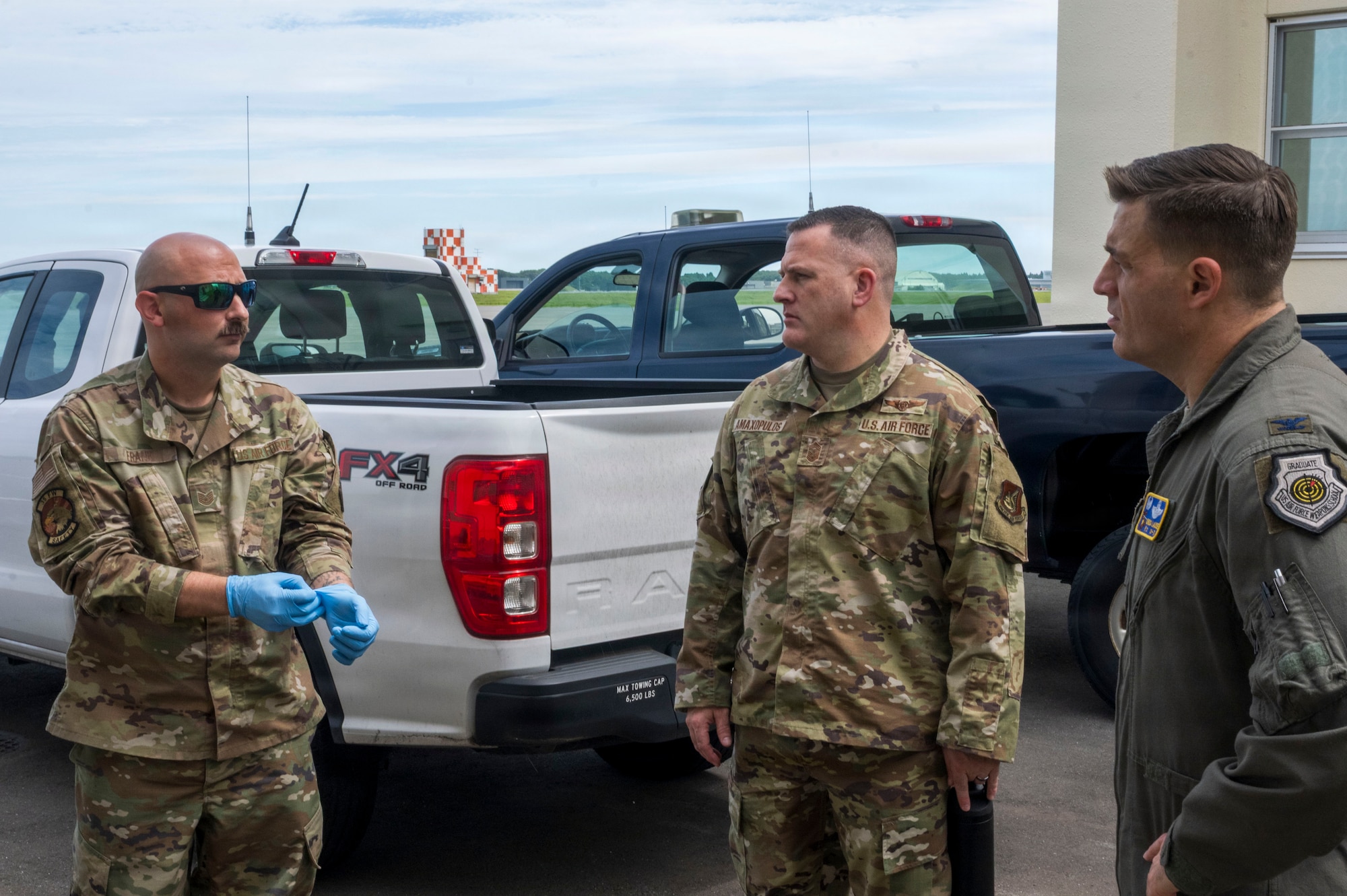U.S. Air Force Tech. Sgt. Christopher Frank, left, 35th Fighter Wing aviation safety noncommissioned officer, briefs Chief Master Sgt. Jason Amaxopulos, center, 35th FW command chief, and Col. Oliver Lause, right, 35th FW commander, during a Wild Weasel Walk-Through at Misawa Air Base, Japan, Aug. 18, 2026.