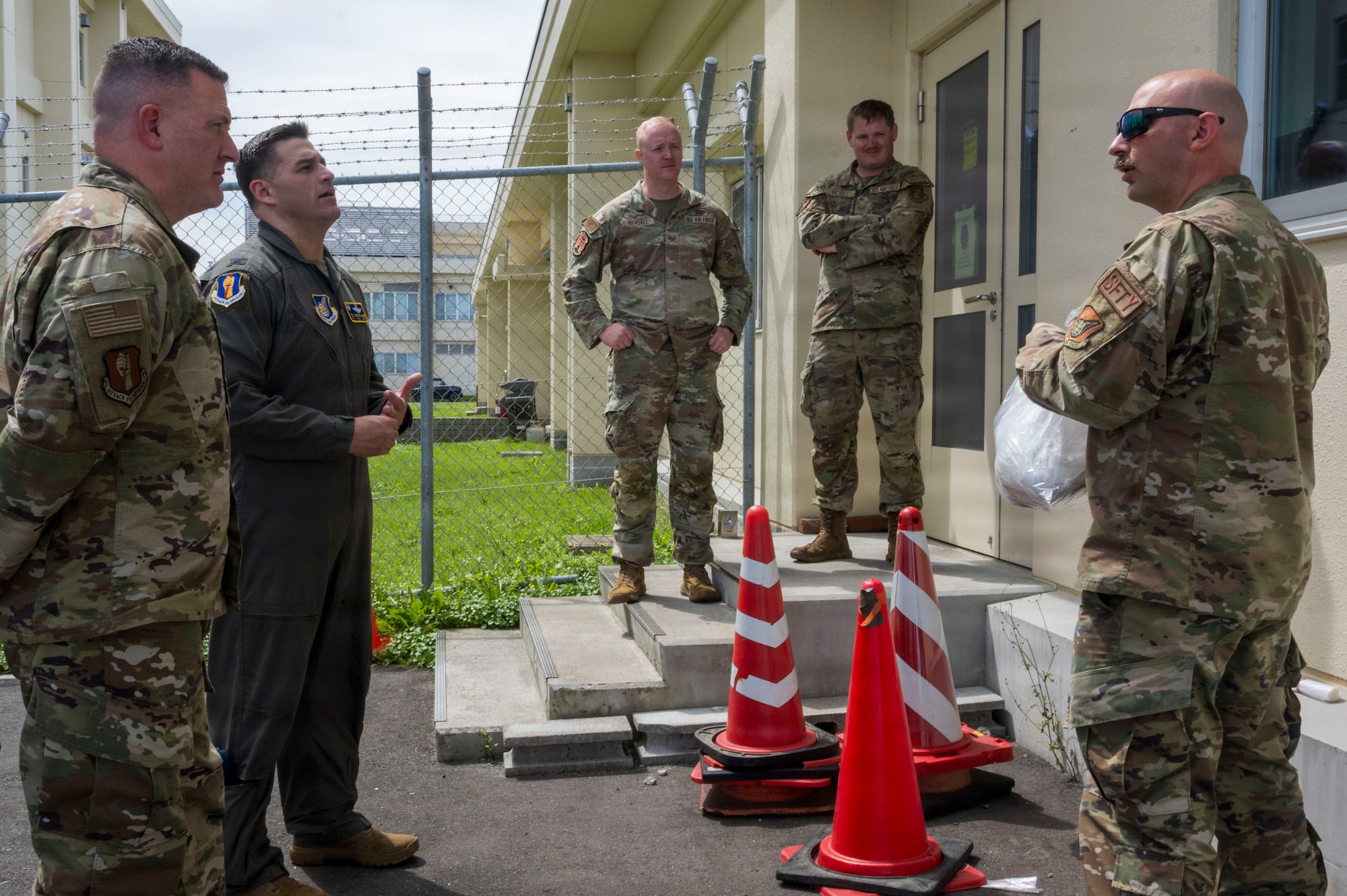 U.S. Air Force Tech. Sgt. Christopher Frank, right, 35th Fighter Wing aviation safety noncommissioned officer, discusses bird-strike response procedures with wing leadership during a Wild Weasel Walk-Through at Misawa Air Base, Japan, Aug. 18, 2026.