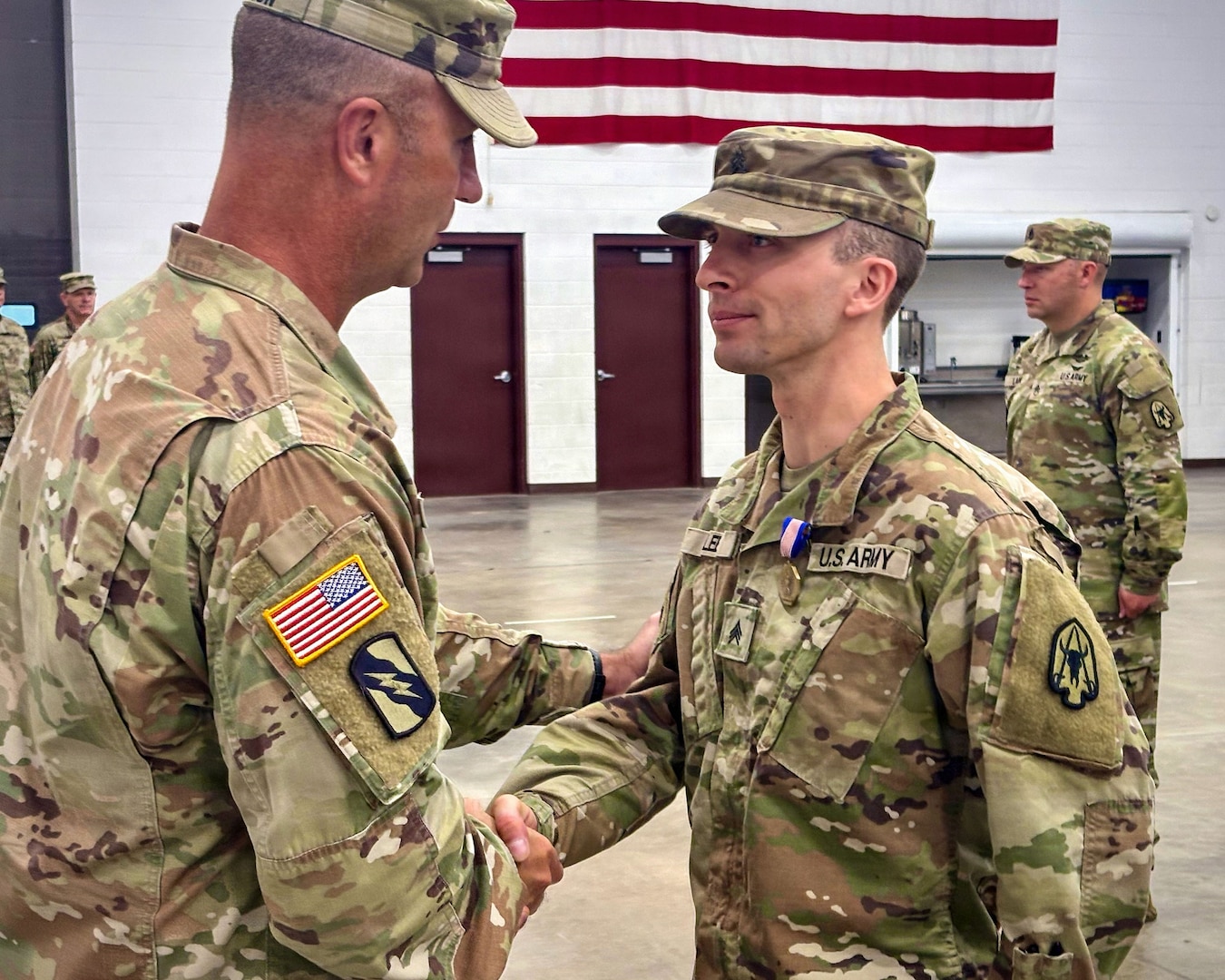 U.S. Army Brig. Gen. Trenton J. Gibson, Adjutant General of the Montana National Guard, congratulates U.S. Army Sgt. Adam M. Lee after presenting him with the Soldier’s Medal at the Belgrade Armory in Belgrade, Montana, Aug. 16, 2026.