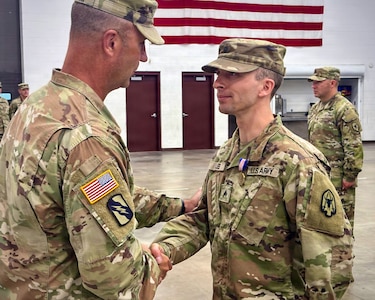 U.S. Army Brig. Gen. Trenton J. Gibson, Adjutant General of the Montana National Guard, congratulates U.S. Army Sgt. Adam M. Lee after presenting him with the Soldier’s Medal at the Belgrade Armory in Belgrade, Montana, Aug. 16, 2026.