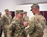 U.S. Army Brig. Gen. Trenton J. Gibson, adjutant general of the Montana National Guard, presents the Soldier’s Medal to U.S. Army Sgt. Adam M. Lee during a ceremony at the Belgrade Armory in Belgrade, Mont., Aug. 16.