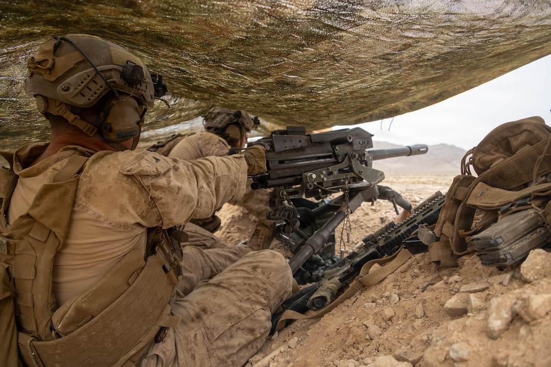 U.S. Marine Corps Lance Cpl. Caleb Thaxton, a native of Ohio and gunner, and Cpl. Carlos Alvarez, a native of Maryland and team leader, both with Golf Company, 2nd Battalion, 2nd Marine Regiment, 2nd Marine Division, fire a Mark 19 grenade machine gun during a company supported bilateral defense, executing combined arms dilemmas against dismounted enemy forces as part of Marine Air-Ground Task Force Distributed Maneuver Exercise on Training Area Delta during Service Level Training Exercise 4-26 on Marine Corps Air Ground Combat Center, Twentynine Palms, California, Aug. 11, 2026. SLTE 4-26 is designed to be a challenging, realistic training environment that produces combat-ready forces capable of operating as an integrated Marine Air-Ground Task Force across all domains of military operations. (U.S. Marine Corps photo by Cpl. Isaac Llanez Delgado)