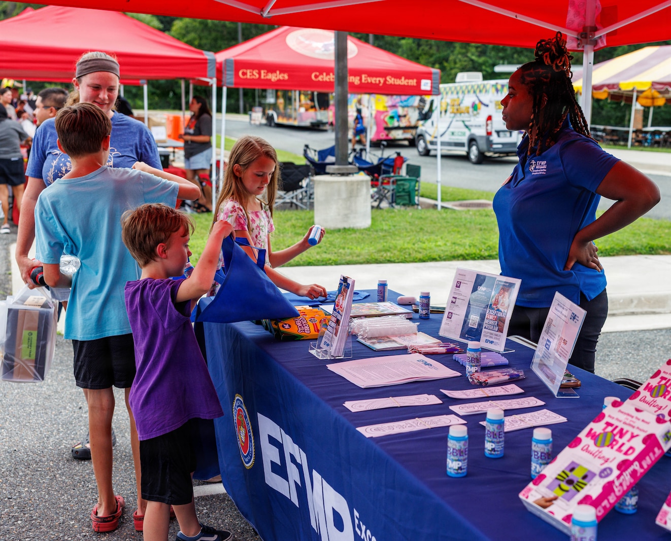 Community members interact with a vendor’s booth during National Night Out at the Crossroads Elementary School on Marine Corps Base Quantico, Virginia, Aug. 4, 2026. National Night Out is an annual community-building campaign that enhances the relationships between law enforcement, first and emergency responders with members of the local community. (U.S. Marine Corps photo by Lance Cpl. Donavan E. Melendez)