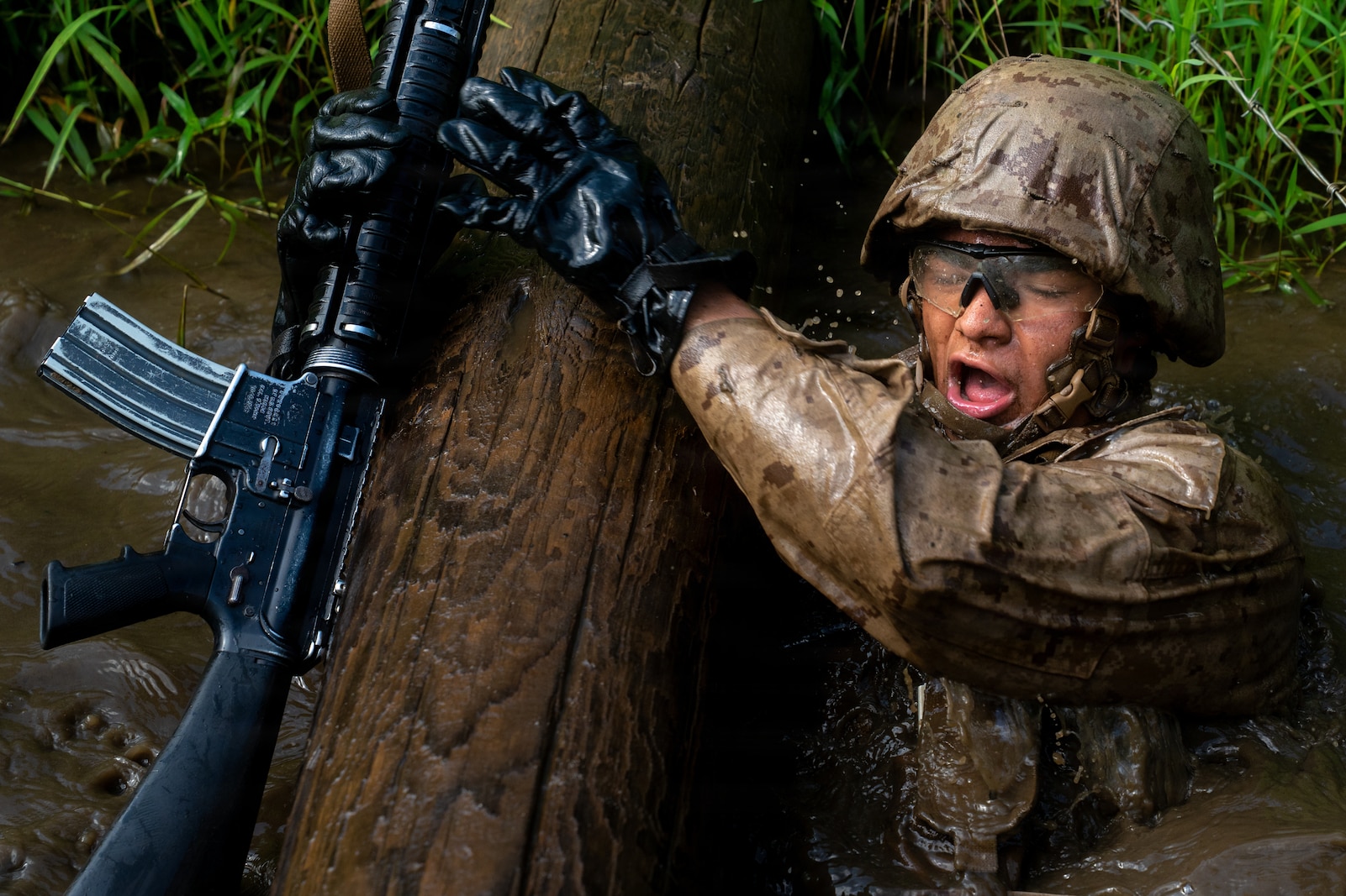 A U.S. Marine Corps officer candidate with Officer Candidate School navigates a water obstacle on the Combat Course at OCS on Marine Corps Base Quantico, Virginia, Aug. 3, 2026. The Combat Course tests officer candidates’ endurance and ability to navigate obstacles under pressure in a simulated combat environment. (U.S. Marine Corps photo by Cpl. Joshua Munsen)