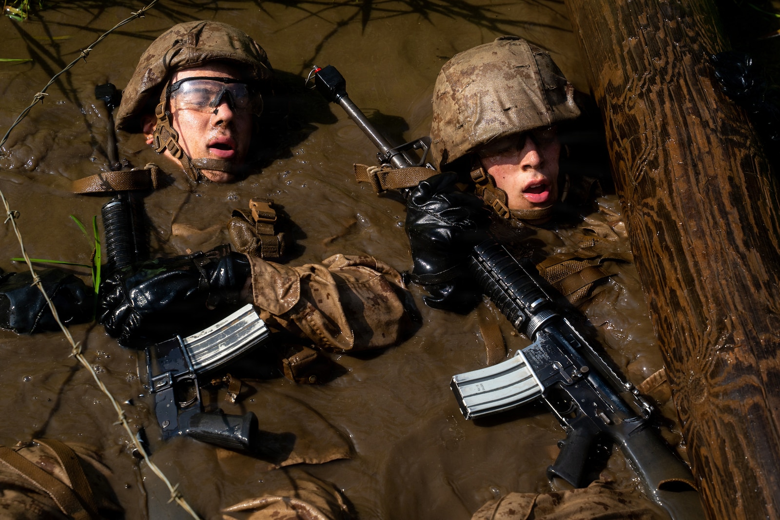 U.S. Marine Corps officer candidates with Officer Candidate School navigate a water obstacle on the Combat Course at OCS on Marine Corps Base Quantico, Virginia, Aug. 3, 2026. The Combat Course tests officer candidates’ endurance and ability to navigate obstacles under pressure in a simulated combat environment. (U.S. Marine Corps photo by Cpl. Joshua Munsen)