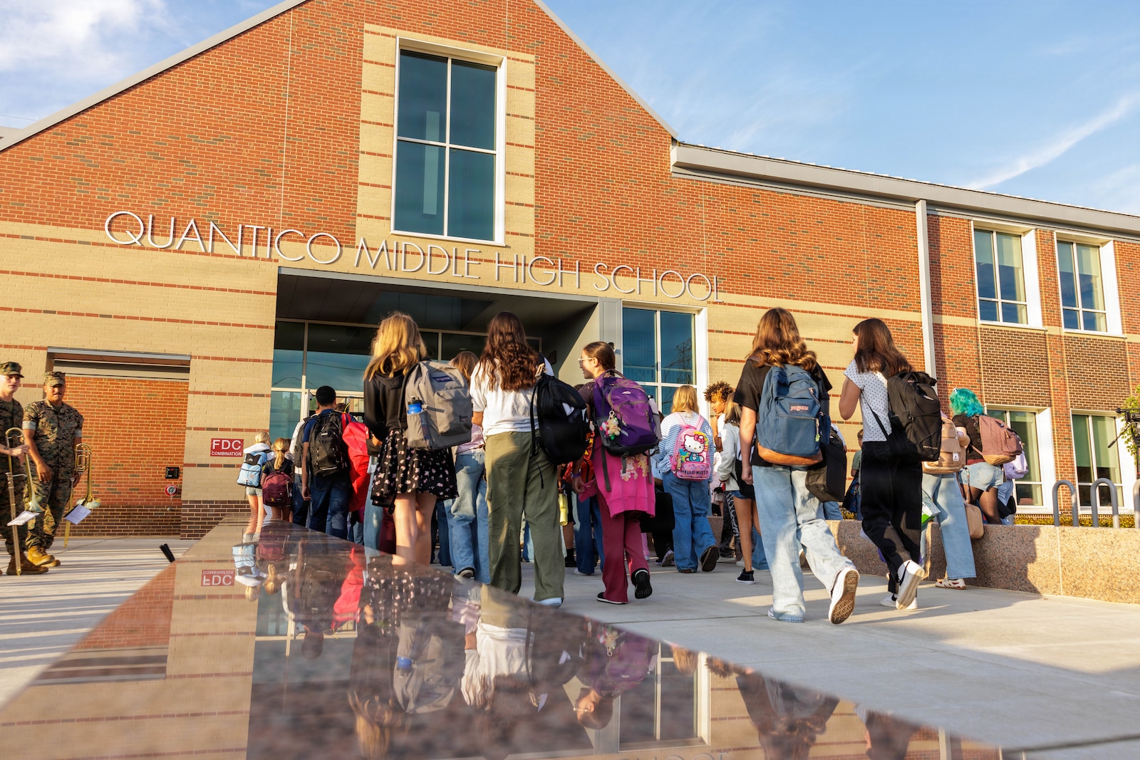 Students of the Quantico Middle-High School walk to their classes on their first day of school during a back-to-school celebration on Marine Corps Base Quantico, Virginia, Aug. 17, 2026. This event welcomed students back to the classrooms, strengthening the bonds between the Marines and the MCB Quantico community. (U.S. Marine Corps photo by Lance Cpl. Federico Marquez)