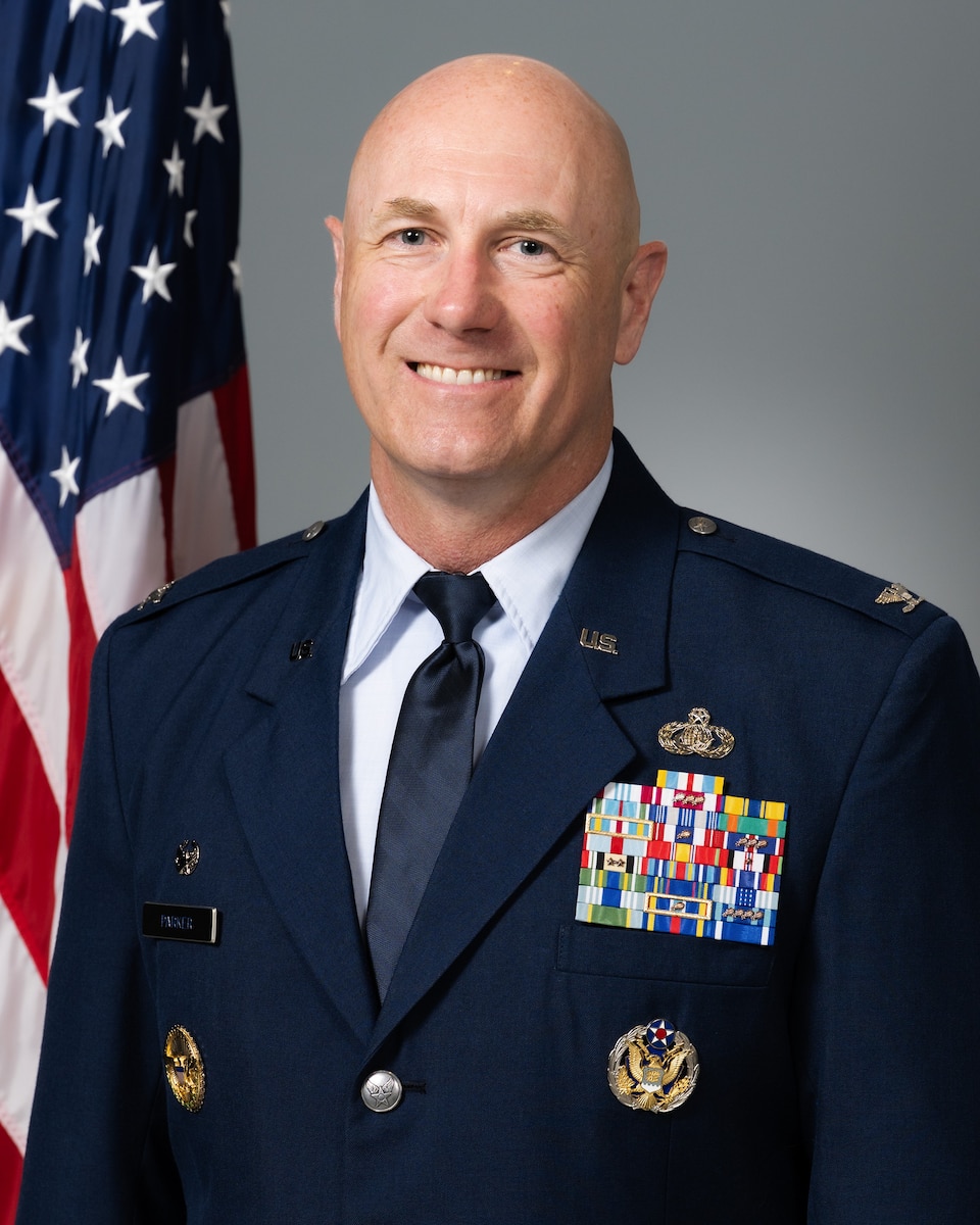 A man in military uniform poses for a photo.