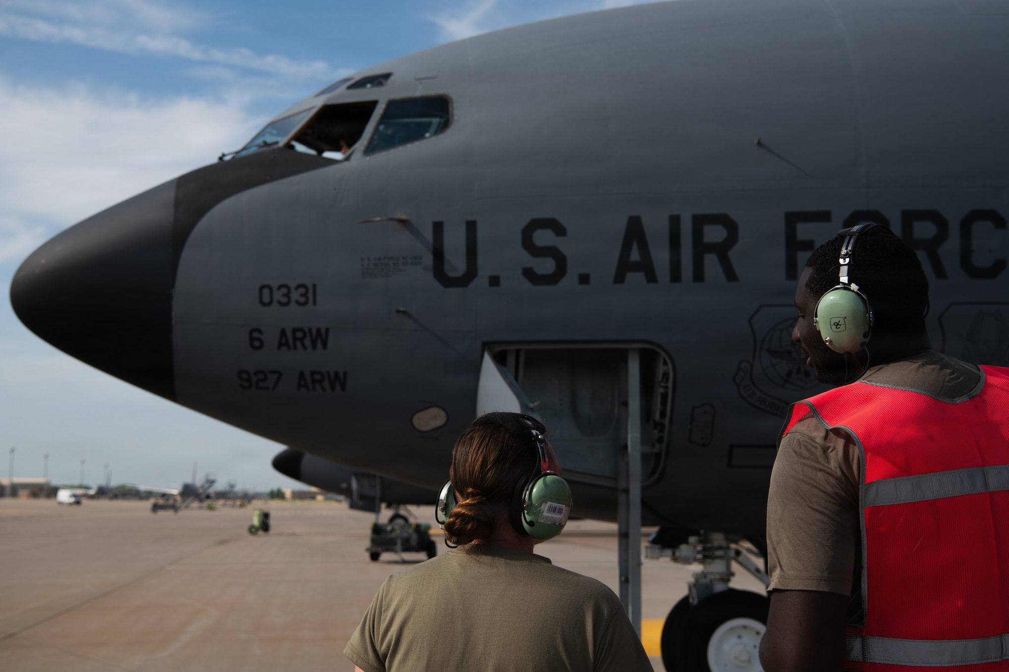 U.S. Air Force Airman 1st Class Hannah Jenkins and Senior Airman Tyrone Banks, 722nd Aircraft Maintenance Squadron, watch as a KC-135 Stratotanker prepares to depart McConnell Air Force Base, Kansas, Aug. 14, 2026. The aircraft’s departure supports the wing’s upcoming tanker transition to the KC-46A Pegasus. (U.S. Air Force photo by Airman Matthew Nguyen)