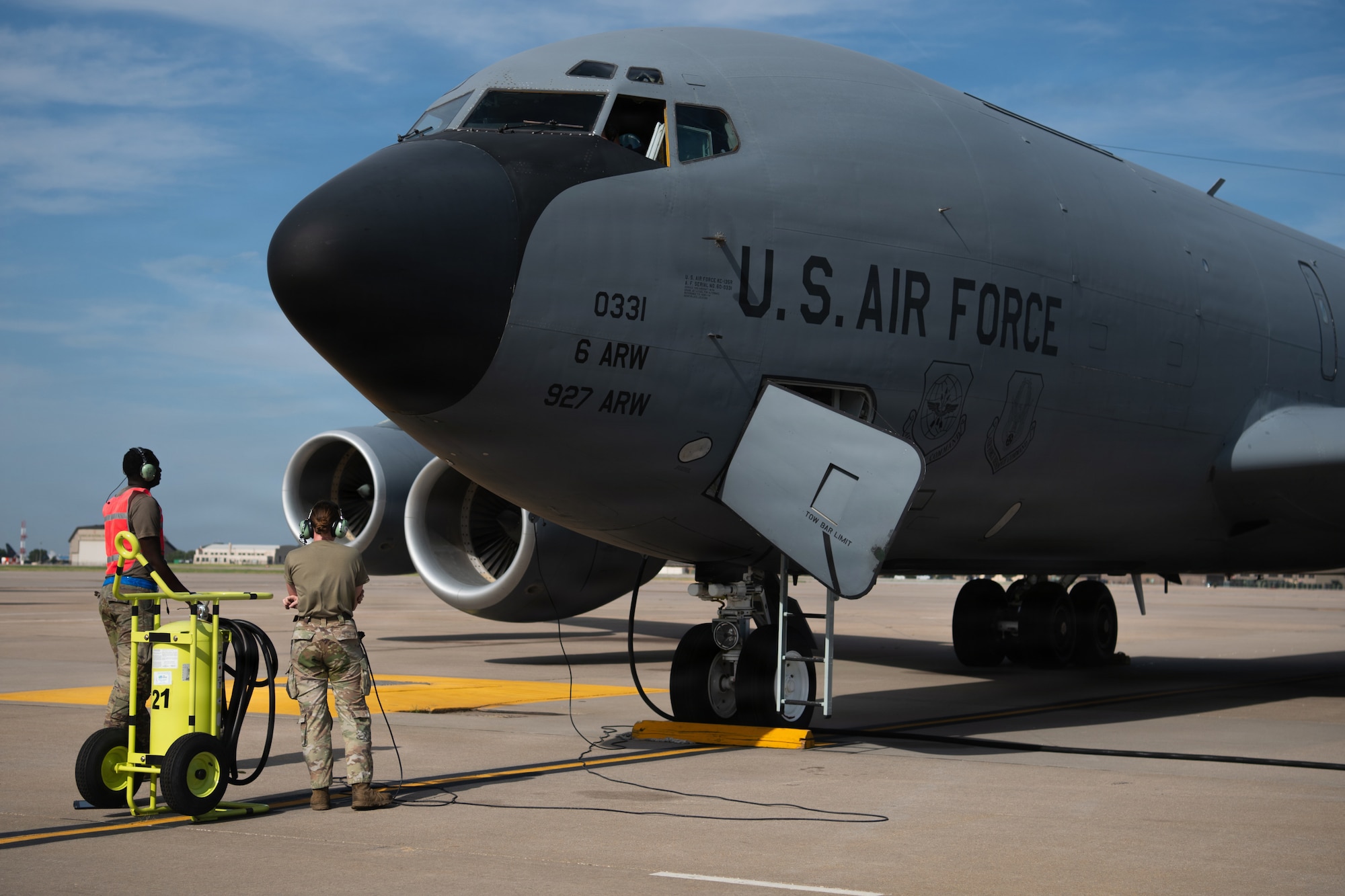 U.S. Air Force Senior Airman Tyrone Banks and Airman 1st Class Hannah Jenkins, 722nd Aircraft Maintenance Squadron, watch as a KC-135 Stratotanker prepares to depart McConnell Air Force Base, Kansas, Aug. 14, 2026. The aircraft’s departure supports the wing’s upcoming tanker transition to the KC-46A Pegasus. (U.S. Air Force photo by Airman Matthew Nguyen)