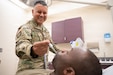Army Reserve Lt. Col. John Huaylinos, a psychiatric nurse practitioner from the Staten Island, N. Y., based Northeast Medical Area Readiness Group, takes a patient's temperature at the DiLorenzo Military Medical Center, the Pentagon, Arlington, Va., on Aug. 11, 2026. Participating in the Medical Readiness Skills Sustainment Program, Army Reserve Soldiers were able to attend their annual training in a military medical environment that places them in front of actual patients and equipment to ensure they are able to meet the needs of military medicine. (U.S. Army Reserve photo by Staff Sgt. Jerry T. Zuetrong)