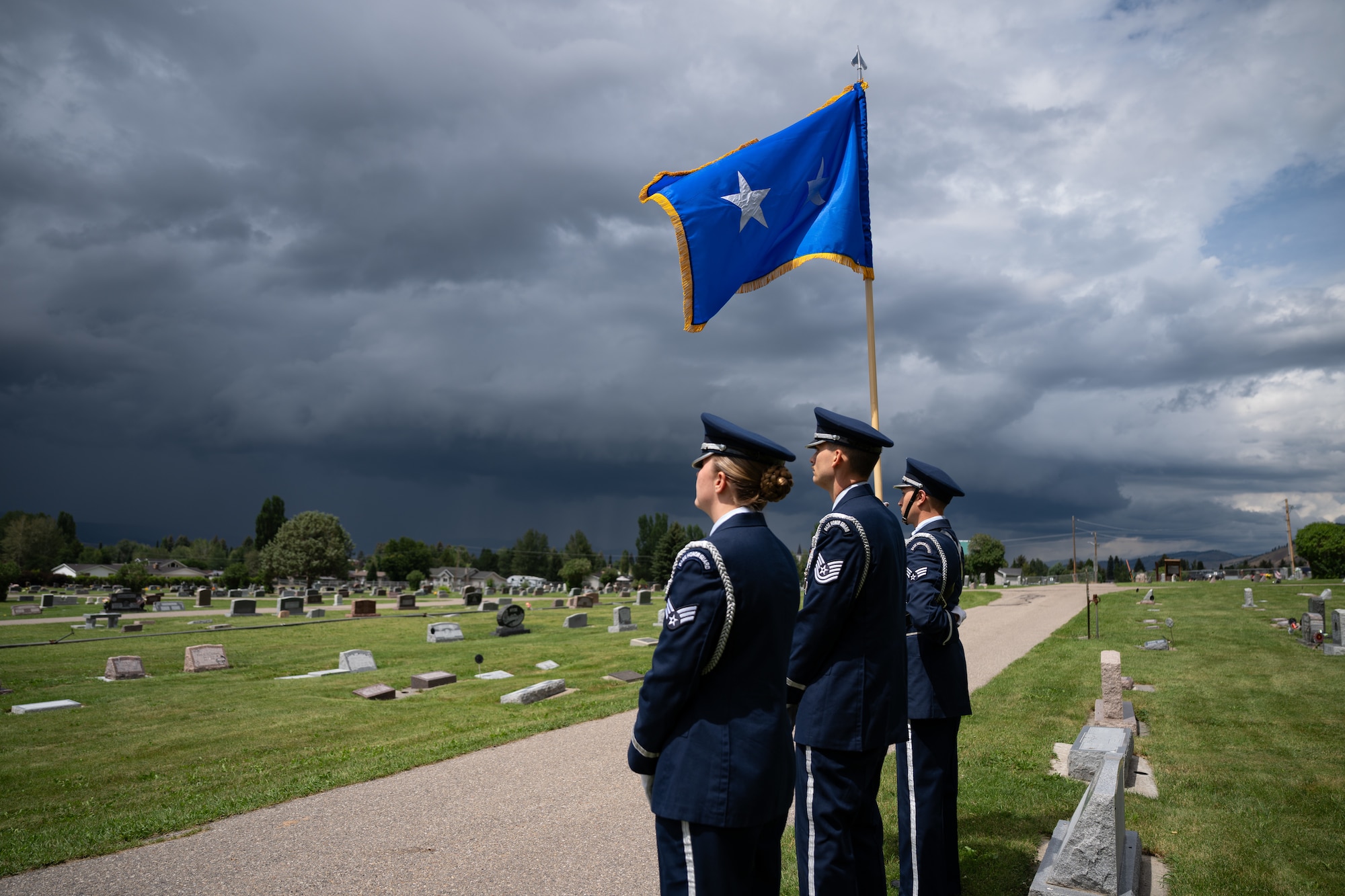 A photo of Air Force honor guard members rendering honors at a funeral.