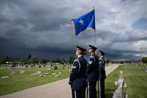 A photo of Air Force honor guard members rendering honors at a funeral.