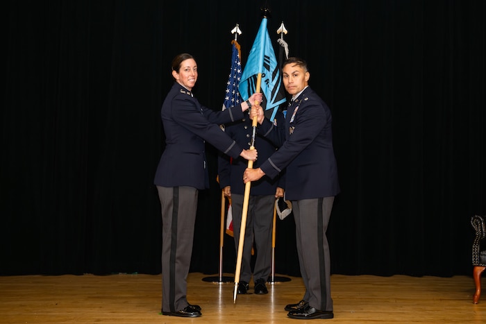 Space Training and Readiness Command, Space Delta 1 commander Col. Krista N. St. Romain (left) officiated the activation, formally passing the command guidon to the new U.S. Space Force’s 320th Recruiting Squadron commander Lt. Col. Jason Cano, during a ceremony Aug. 14 at the Parr Club. The moment marked a decisive step in shaping the force needed for tomorrow’s space mission.