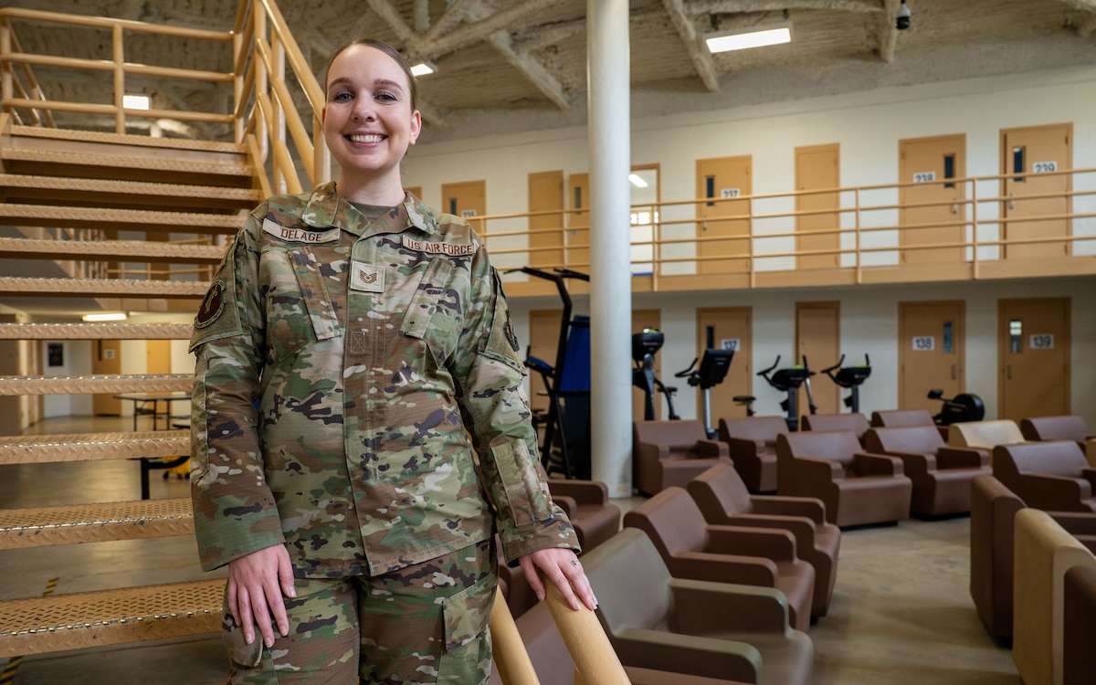 Female Airman standing on stairs.